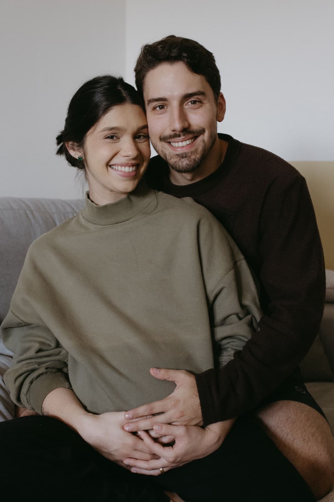 Smiling couple sitting closely together at home